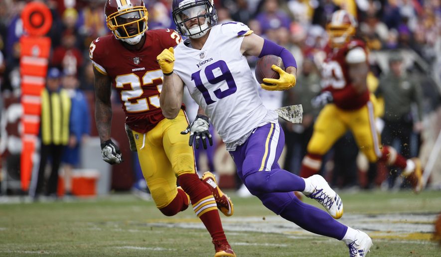 Minnesota Vikings wide receiver Adam Thielen (19) carries the ball past Washington Redskins free safety DeAngelo Hall (23) during the first half of an NFL football game in Landover, Md., Sunday, Nov. 12, 2017. (AP Photo/Patrick Semansky)