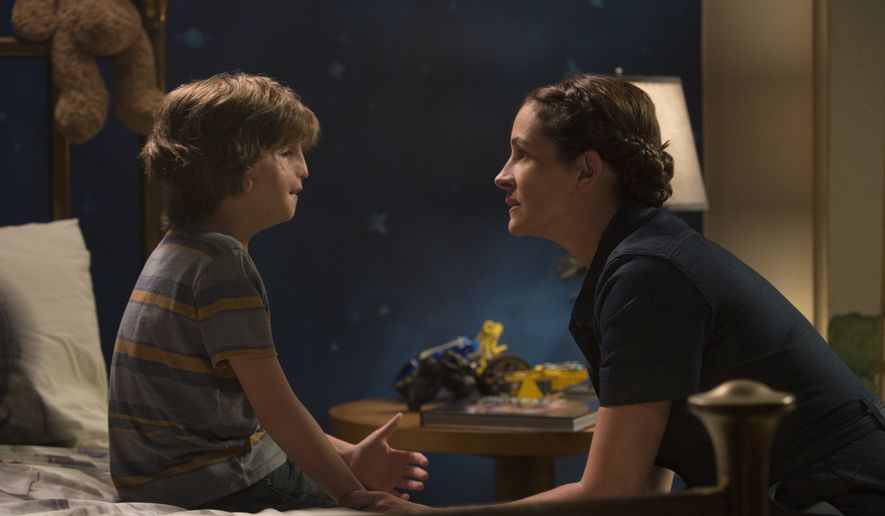 This image released by Lionsgate shows Jacob Tremblay, left, and Julia Roberts in a scene from &quot;Wonder.&quot; (Dale Robinette/Lionsgate via AP)