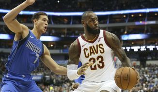 Cleveland Cavaliers forward LeBron James (23) is defended by Dallas Mavericks forward Dwight Powell (7) during the first half of an NBA basketball game in Dallas, Saturday, Nov. 11, 2017. (AP Photo/LM Otero)