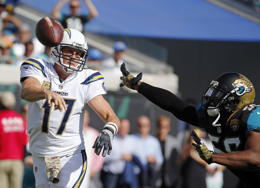 Los Angeles Chargers quarterback Philip Rivers (17) throws a pass as he is pressured by Jacksonville Jaguars defensive end Dante Fowler Jr., during the first half of an NFL football game, Sunday, Nov. 12, 2017, in Jacksonville, Fla. (AP Photo/Stephen B. Morton)