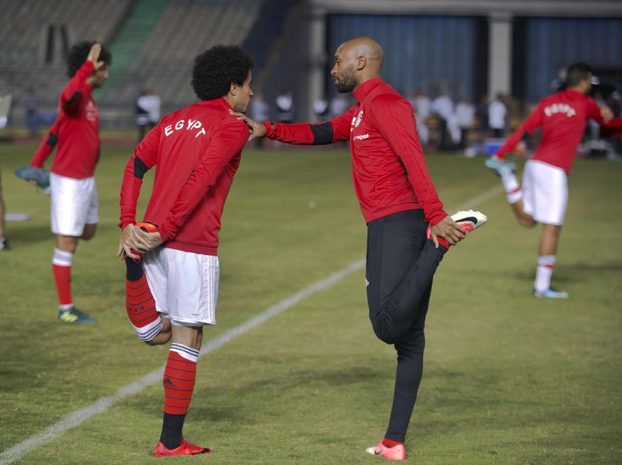 FILE - In this Nov. 6, 2017 photo, Omar Gaber, who plays for Swiss Super League side FC Basel, left, chats with Shikabala, whose real name is Mahmoud Abdel-Razeq, as they warm up with the national team, in Cairo stadium, Egypt. A surprise call-up for international duty has given striker Shikabala a comeback that could even bring on better things -- a place for the 31-year-old journeyman in the Egypt squad traveling to the 2018 World Cup in Russia. (AP Photo/Amr Nabil)