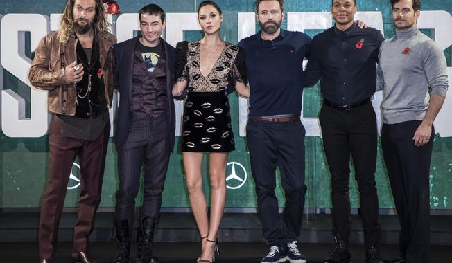 FILE - This Nov. 3, 2017 file photo shows &amp;quot;Justice League&amp;quot; cast members Jason Momoa, from left, Ezra Miller, Gal Gadot, Ben Affleck, Ray Fisher and Henry Cavill at a photo call for the film in London.  The film opens on Friday. (Photo by Vianney Le Caer/Invision/AP, File)