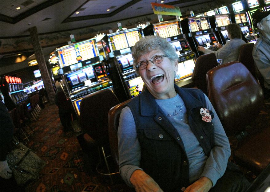 In this Nov. 1, 2017, photo, Lil Spravzoff, of Bismarck, takes a break from playing a slot machine at Prairie Knights Casino and Lodge south of Mandan, N.D., to talk about how she and her late husband would drive to the casino for concerts. Finances at the casino run by the Standing Rock Sioux Tribe are slowly improving, after facing a $6 million shortfall during the peak of the Dakota Access crude oil pipeline protest in February. (Mike McCleary/The Bismarck Tribune via AP)