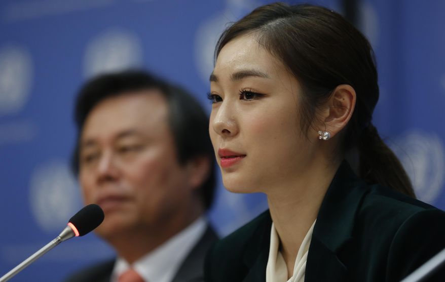 South Korea's 2010 Olympic gold medalist figure skater Yuna Kim, right, speaks during a press conference, Monday Nov. 13, 2017 at U.N. headquarters. The U.N. General Assembly adopted a South Korea sponsored resolution that 2018 Pyeong Chang Winter Olympics build a peaceful and better world through sport and Olympic ideal. (AP Photo/Bebeto Matthews)
