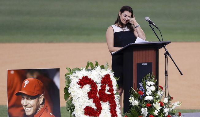 Brandy Halladay, wife of late pitcher Roy Halladay, wipes her eyes while talking about her husband during an event honoring his life, at Spectrum Field in Clearwater, Fla., Tuesday, Nov. 14, 2017. Halladay, a two-time Cy Young Award winner, died Nov. 7 at age 40 when the private plane he was piloting crashed into the Gulf of Mexico off the coast of Florida. (Yong Kim/The Philadelphia Inquirer via AP)