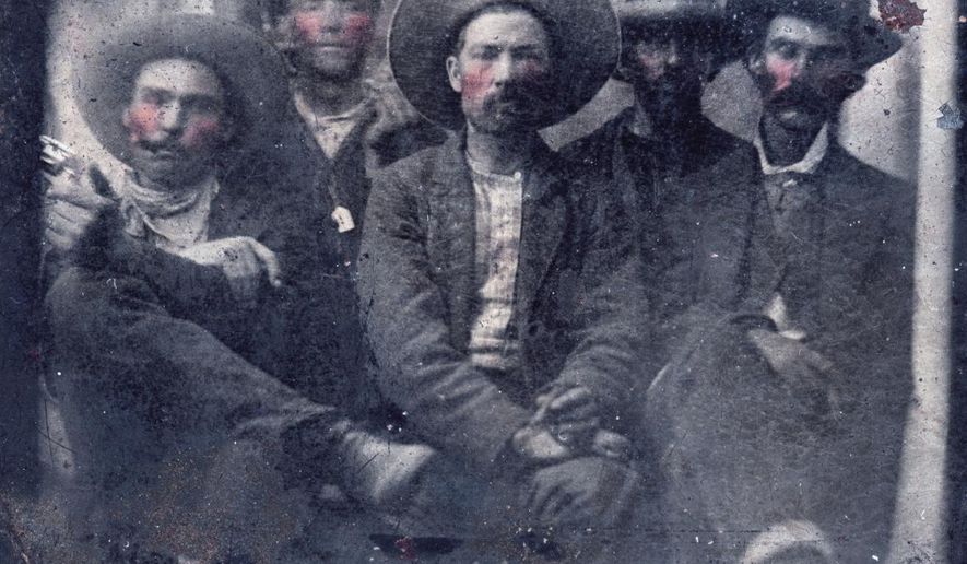 This photo provided by Frank Abrams shows what historians believe is a photo of outlaw Billy the Kid, second from left, and Pat Garrett, far right, taken in 1880. Frank Abrams, who bought the photo at a flea market says experts in forensics and facial recognition have verified the picture after several months of examination. (Courtesy of Frank Abrams via AP)