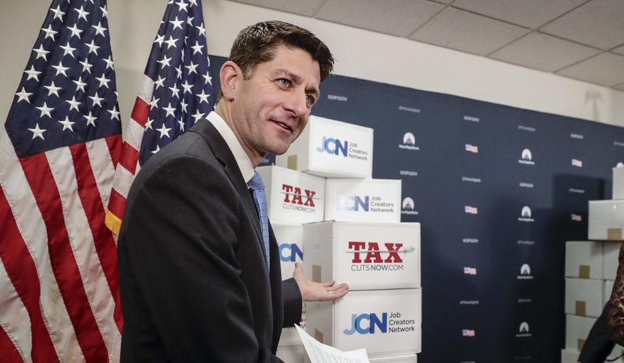 Speaker of the House Paul Ryan, R-Wis., points to boxes of petitions supporting the Republican tax reform bill that is set for a vote later this week as he arrives for a news conference on Capitol Hill in Washington, Tuesday, Nov. 14, 2017. (AP Photo/J. Scott Applewhite)