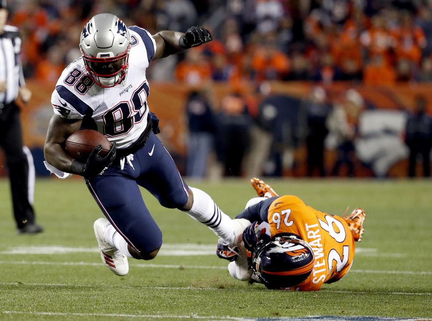 FILE - In this Sunday, Nov. 12, 2017, file photo, New England Patriots tight end Martellus Bennett (88) is tripped up by Denver Broncos free safety Darian Stewart (26) during the first half of an NFL football game in Denver. Bennett is still coming to terms with how his Green Bay tenure ended. But he says being back in familiar surroundings is helping him to deal with it. (AP Photo/Jack Dempsey, File)