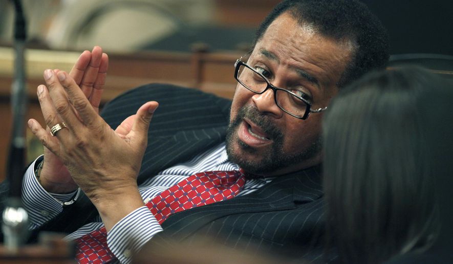 FILE - In a Jan. 6, 2010 file photo, Pennsylvania state Rep. Jewell Williams, D-Philadelphia, talks with a colleague on the floor of the Pennsylvania House of Representatives in Harrisburg, Pa. Williams, currently serving as the Sheriff of Philadelphia, is denying allegations of sexual harassment made by several women. The Philadelphia Inquirer reported Tuesday, Nov. 14, 2017 that Williams called the accusations "without merit." (AP Photo/Carolyn Kaster, File)
