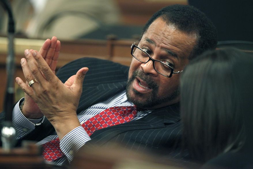 FILE - In a Jan. 6, 2010 file photo, Pennsylvania state Rep. Jewell Williams, D-Philadelphia, talks with a colleague on the floor of the Pennsylvania House of Representatives in Harrisburg, Pa. Williams, currently serving as the Sheriff of Philadelphia, is denying allegations of sexual harassment made by several women. The Philadelphia Inquirer reported Tuesday, Nov. 14, 2017 that Williams called the accusations "without merit." (AP Photo/Carolyn Kaster, File)