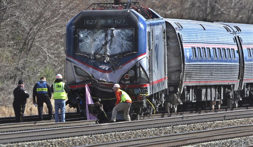 FILE - In this April 3 2016, file photo, Amtrak investigators inspect the deadly train crash in Chester, Pa. The Amtrak train struck a piece of construction equipment just south of Philadelphia causing a derailment. The National Transportation Safety Board is set to review the findings of an investigation into what caused a speeding Amtrak train to slam into a backhoe last year near Philadelphia, killing two maintenance workers. The board is meeting Tuesday, Nov. 14, 2017, in Washington to determine a probable cause of the deadly crash. (Michael Bryant/The Philadelphia Inquirer via AP, File)
