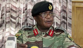 Zimbabwean army commander Constantino Chiwenga Harare held a press conference Monday in Harare, where he threatened to step in to calm political tensions over President Robert Mugabe&#39;s firing of his deputy. A day later, armored personnel carriers were seen outside the capital. (Associated Press)