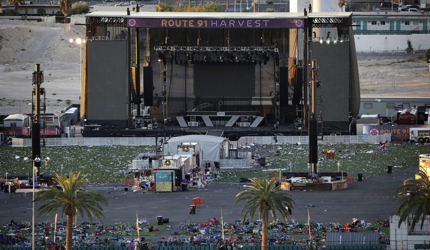 FILE - In this Tuesday, Oct. 3, 2017, file photo, debris litters a concert festival grounds after a mass shooting in Las Vegas. Legal action stemming from the mass shooting at the concert is picking up with lawsuits filed Wednesday, Nov. 15, on behalf of 14 concertgoers. (AP Photo/John Locher, File)