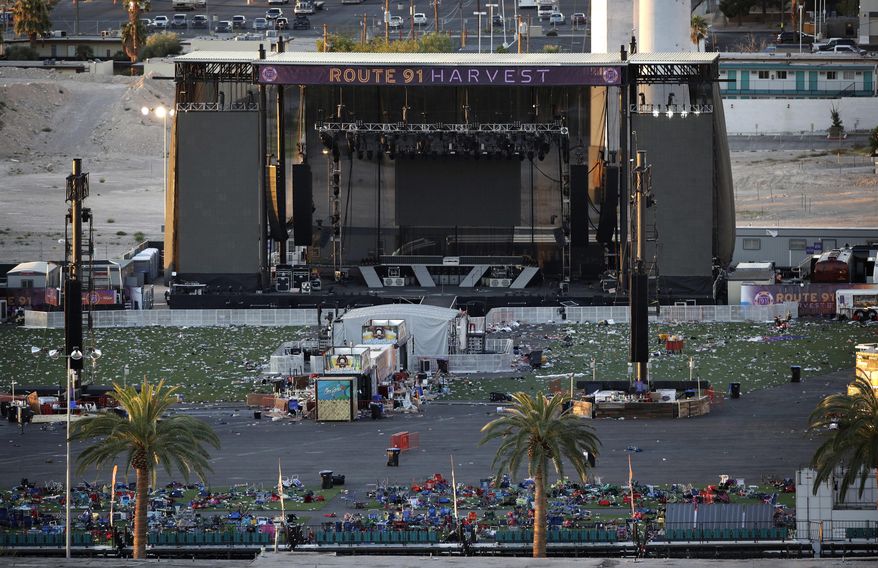 FILE - In this Tuesday, Oct. 3, 2017, file photo, debris litters a concert festival grounds after a mass shooting in Las Vegas. Legal action stemming from the mass shooting at the concert is picking up with lawsuits filed Wednesday, Nov. 15, on behalf of 14 concertgoers. (AP Photo/John Locher, File)