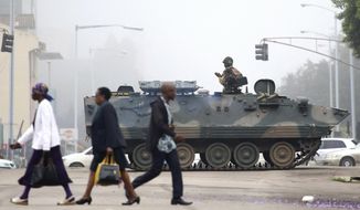 An armed soldier patrols a street in Harare, Zimbabwe, Wednesday, Nov. 15, 2017. Zimbabwe&#39;s army said Wednesday it has President Robert Mugabe and his wife in custody and is securing government offices and patrolling the capital&#39;s streets following a night of unrest that included a military takeover of the state broadcaster. (AP Photo)