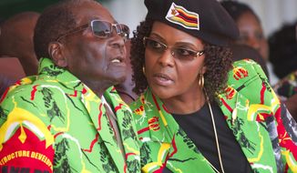 FILE - In this June, 2, 2017 file photo Zimbabwean President Robert Mugabe, left, and his wife Grace follow proceedings during a youth rally in Marondera Zimbabwe. (AP Photo/Tsvangirayi Mukwazhi, File)