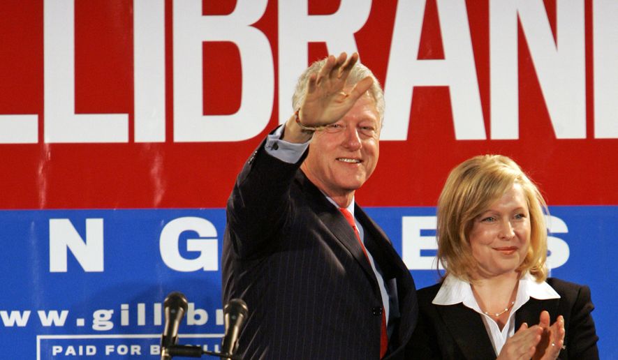 In this Oct. 26, 2006, file photo, Former President Bill Clinton and Kirsten Gillibrand, a Democratic lawyer who is running against three-term Rep. John Sweeney, R-N.Y., acknowledge the crowd at a rally in Albany, N.Y. U.S. Sen. Kirsten Gillibrand said, in an interview in The New York Times, that former President Clinton should have resigned over his sexual affair with White House intern Monica Lewinsky 20 years ago.  (AP Photo/Jim McKnight, File)
