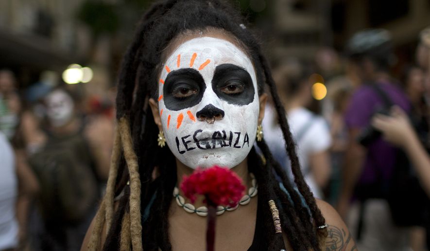 A woman with the word &quot;Legalize&quot; painted across her mouth marched in Rio de Janeiro against a recent congressional committee vote to make abortion illegal without exception throughout Brazil. (Associated Press/File)
