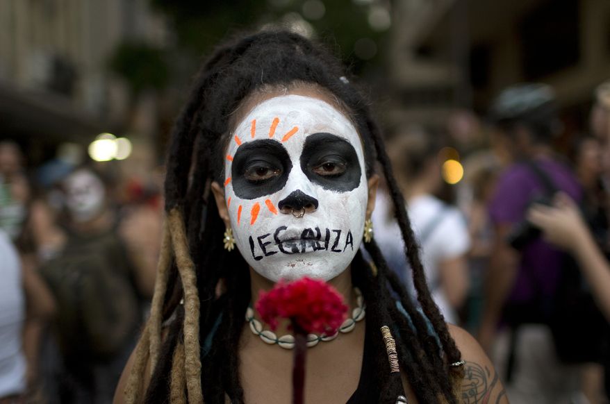 A woman with the word "Legalize" painted across her mouth marched in Rio de Janeiro against a recent congressional committee vote to make abortion illegal without exception throughout Brazil. (Associated Press/File)