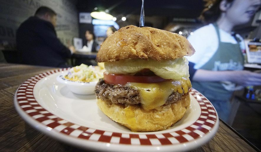A 100 percent U.S. Angus beef Colby Jack Cheeseburger as part of U.S. President Donald Trump set is seen at Munch&#39;s Burger Shack restaurant in Tokyo Thursday, Nov. 16, 2017. The cheeseburger Trump had during his recent visit to Japan is still drawing lines at the Tokyo burger joint. (AP Photo/Eugene Hoshiko)