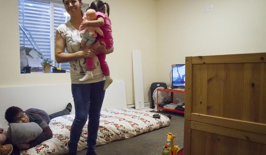 ADVANCE FOR WEEKEND EDITIONS, NOV 18 -19 - In this Saturday, Nov. 11, 2017 photo, Sandra Lopez and her 2-year-old daughter Areli play together in their small basement apartment in a parsonage in Carbondale, Colo. Lopez, a 42-year-old woman who has taken sanctuary against deportation in a Carbondale parsonage, came to the U.S. nearly 20 years ago, running away from the violence, government corruption and poverty of Chihuahua, Mexico (Chelsea Self/Glenwood Springs Post Independent via AP)