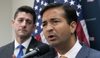 In this Oct. 24, 2017, file photo, Rep. Carlos Curbelo, R-Fla., right, stands with Speaker of the House Paul Ryan, R-Wis., left, discussing the GOP agenda for tax reform during a news conference on Capitol Hill in Washington. (AP Photo/J. Scott Applewhite, File)