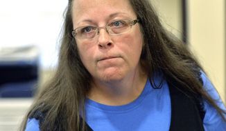 FILE - In this Sept. 1, 2015, file photo, Rowan County Clerk Kim Davis listens to a customer at the Rowan County Courthouse in Morehead, Ky. Elwood Caudill says he plans to run for county clerk against Davis, who caused an uproar in 2015 when she refused to issue marriage licenses because of her opposition to same-sex marriage. Caudill ran against Davis in 2014 in the Democratic primary, but lost by 23 votes. In 2018, Caudill will run as a Democrat while Davis has switched parties to become a Republican. (AP Photo/Timothy D. Easley, File)