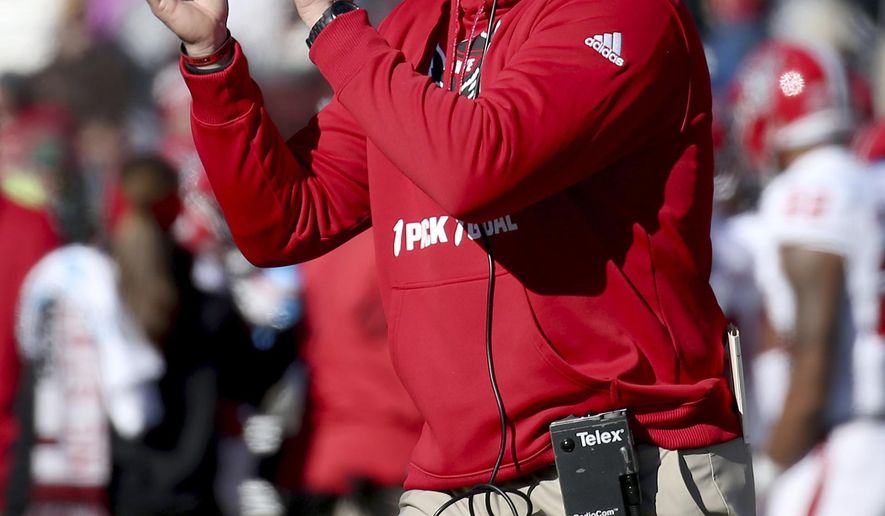 North Carolina State head coach Dave Doeren encourages his team during a timeout in the first half of an NCAA college football game against Boston College, Saturday, Nov. 11, 2017, in Boston. (AP Photo/Mary Schwalm)