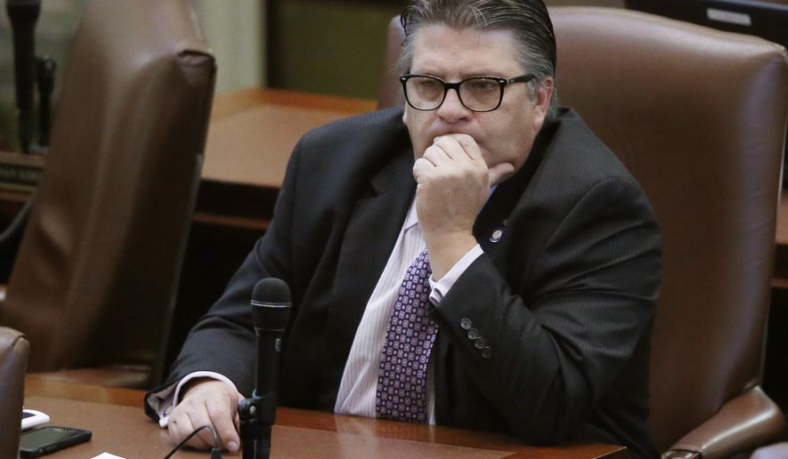 FILE - In this Thursday, Jan. 5, 2017 file photo, Oklahoma state Rep. Scott Fetgatter, R- Okmulgee, listens on the floor of the Oklahoma House in Oklahoma City. Oklahoma legislators have been unable for weeks to reach an agreement on how to plug a $215 million hole in the state budget, but they don't appear to be having problems raising thousands of dollars from lobbyists at lavish fundraisers. (AP Photo/Sue Ogrocki, File)