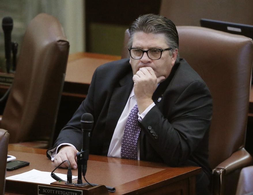 FILE - In this Thursday, Jan. 5, 2017 file photo, Oklahoma state Rep. Scott Fetgatter, R- Okmulgee, listens on the floor of the Oklahoma House in Oklahoma City. Oklahoma legislators have been unable for weeks to reach an agreement on how to plug a $215 million hole in the state budget, but they don't appear to be having problems raising thousands of dollars from lobbyists at lavish fundraisers. (AP Photo/Sue Ogrocki, File)