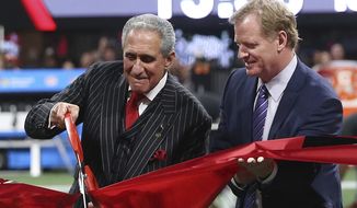 NFL commissioner Roger Goodell, right, helps Atlanta Falcons owner Arthur Blank cut the ribbon for the opening of the new Mercedes-Benz stadium before the first of an NFL football game between the Atlanta Falcons and the Green Bay Packers, Sunday, Sept. 17, 2017, in Atlanta. (AP Photo/John Bazemore)