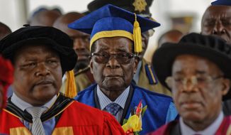 Zimbabwe&#39;s President Robert Mugabe, center, arrives to preside over a student graduation ceremony at Zimbabwe Open University on the outskirts of Harare, Zimbabwe Friday, Nov. 17, 2017. Mugabe is making his first public appearance since the military put him under house arrest earlier this week. (AP Photo/Ben Curtis)