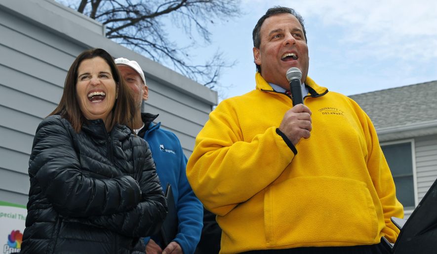 FILE- In this Jan. 31, 2014, file photo, first lady Mary Pat Christie, left, laughs as New Jersey Gov. Chris Christie greet volunteers and family and neighbors outside a renovated home that was heavily damaged by Superstorm Sandy in Moonachie, N.J. Christie and first lady Mary Pat Christie are expected to be on hand Monday, Nov. 20, 2017, when a new access road to Central Park of Morris County is christened “Governor Chris Christie Way.”(AP Photo/Mel Evans, File)