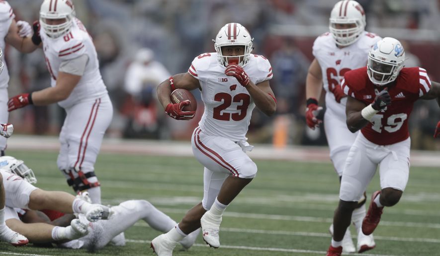 FILE - In this Nov. 4, 2017, file photo, Wisconsin running back Jonathan Taylor (23) runs in the first half of an NCAA college football game against Indiana in Bloomington, Ind. No. 5 Wisconsin will face its sternest test yet this season when No. 19 Michigan visits Camp Randall Stadium in the home season finale. (AP Photo/Darron Cummings)