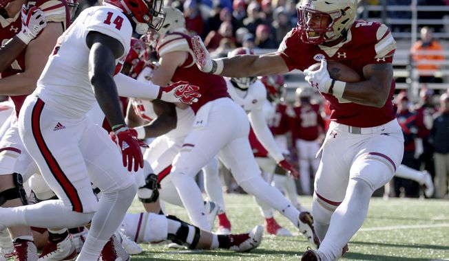 Boston College running back AJ Dillon (2) rushes against the defense of North Carolina State safety Dexter Wright (14) during the first half of an NCAA college football game Saturday, Nov. 11, 2017, in Boston. (AP Photo/Mary Schwalm)