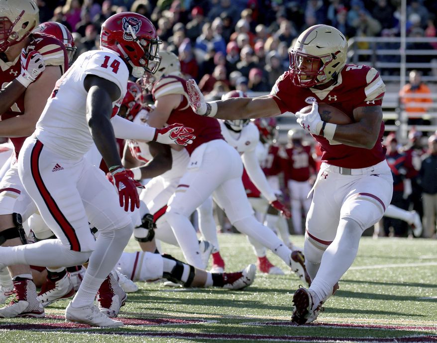 Boston College running back AJ Dillon (2) rushes against the defense of North Carolina State safety Dexter Wright (14) during the first half of an NCAA college football game Saturday, Nov. 11, 2017, in Boston. (AP Photo/Mary Schwalm)