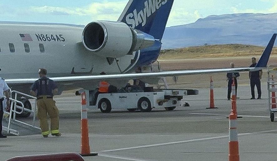 In this Friday, Nov. 17, 2017, photo provided by passenger Don Bumps shows a SkyWest plane in southern Utah, which lost a piece of the plane&#39;s engine during a flight from St. George, Utah. Passengers Scott Jackson and Don Bumps say they heard a loud bang and felt vibrations about 20 minutes into the flight from St. George to Phoenix. Jackson says the pilot then made a slow turn over the Grand Canyon and the plane returned safely to the airport, where the pilot told the passengers the cause was a detached piece of cowling. SkyWest spokeswoman Marissa Snow said the Bombardier CRJ200 regional jet returned to the airport due to an engine warning. ( Don Bumps via AP)