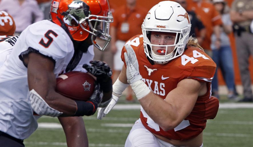 FILE - In this Oct. 21, 2017, file photo, Texas linebacker Breckyn Hager (44) pursues Oklahoma State running back Justice Hill (5) during the first half of an NCAA college football game in Austin, Texas. Texas plays at No. 24 West Virginia on Saturday. When asked about what makes playing at West Virginia a tough venue for opponents, Hager told reporters, "it's a bunch of hillbillies drinking moonshine." (AP Photo/Michael Thomas, File)
