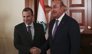 Lebanon&#39;s Foreign Minister Gebran Bassil, left, shakes hands with his Turkish counterpart Mevlut Cavusoglu, right, after their joint news conference following their meeting in Ankara, Turkey, Thursday, Nov. 16, 2017. (AP Photo/Burhan Ozbilici)