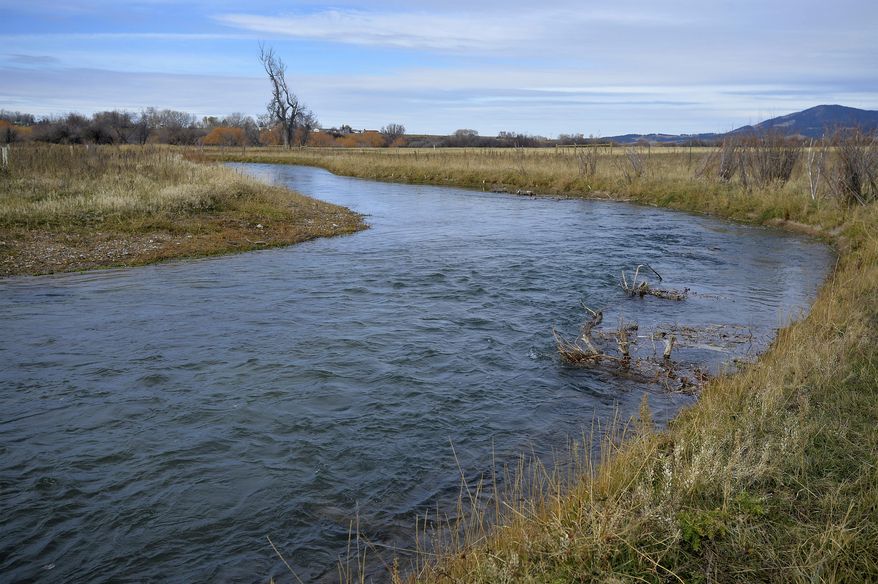 This October 2017 photo shows Big Spring Creek, which was restored to it's original path through land owned by Mark and Sheila Machler, in Lewistown, Mont. Machler's uncle straightened the creek in 1961, which accelerated erosion along the straightened stretch of the water. (Rion Sanders /The Great Falls Tribune via AP)