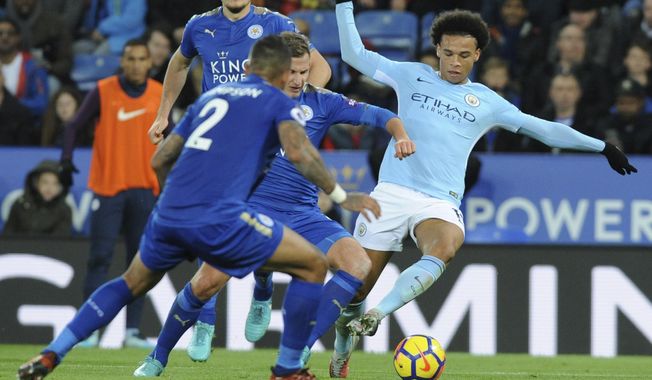 Manchester City&#x27;s Leroy Sane, right, battles for the ball with Leicester&#x27;s Danny Simpson, left, and Leicester&#x27;s Marc Albrighton, centre, during the English Premier League soccer match between Leicester City and Manchester City at the King Power Stadium in Leicester, England, Saturday, Nov. 18, 2017. (AP Photo/Rui Vieira)