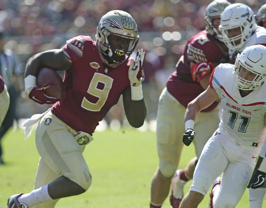 Florida State's Jacques Patrick gets past Delaware State's Brock Nichols to score in the first quarter of an NCAA college football game, Saturday, Nov. 18, 2017, in Tallahassee Fla. (AP Photo/Steve Cannon)