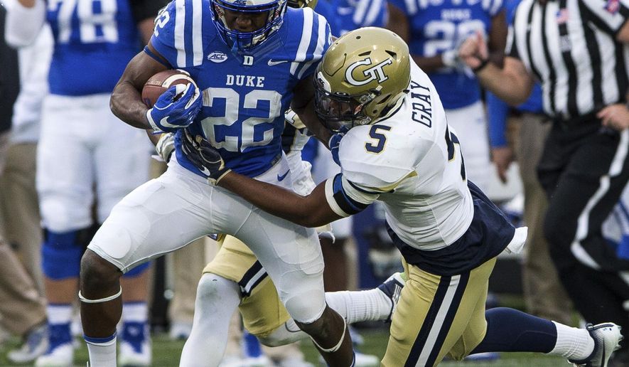 Duke's Brittain Brown (22) carries the ball as Georgia Tech's A.J. Gray (5) attempts a tackle during the first half of an NCAA college football game in Durham, N.C., Saturday, Nov. 18, 2017. (AP Photo/Ben McKeown)