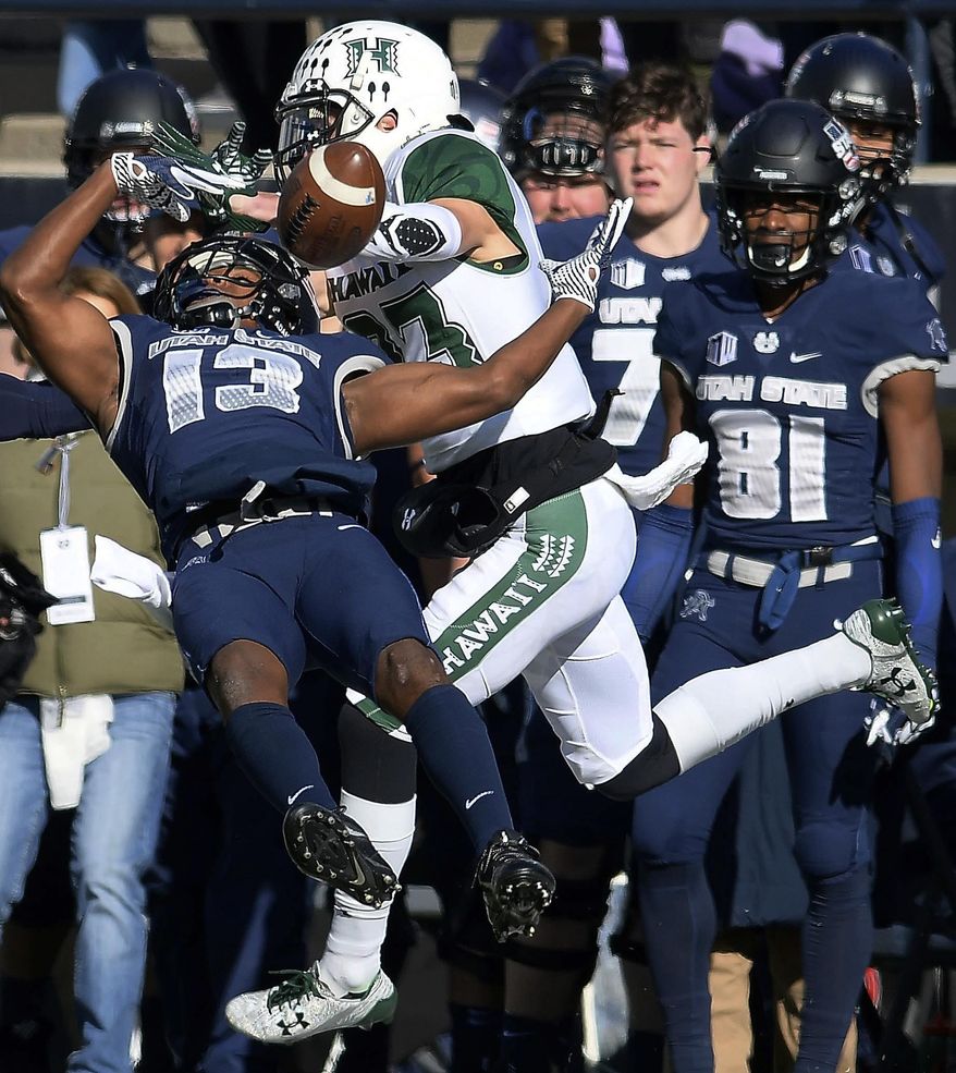 Utah State cornerback Jalen Davis (13) breaks up a pass intended for Hawaii wide receiver Dylan Collie (23) during an NCAA college football game, Saturday, Nov. 18, 2017, in Logan, Utah. Utah State won 38-0. (Eli Lucero/The Herald Journal via AP)