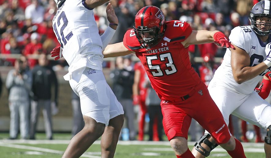Texas Tech's Eli Howard (53) moves in as TCU's Shawn Robinson (12) throws a pass during the first half of the NCAA college football game Saturday, Nov. 18, 2017, in Lubbock, Texas. (AP Photo/Brad Tollefson)
