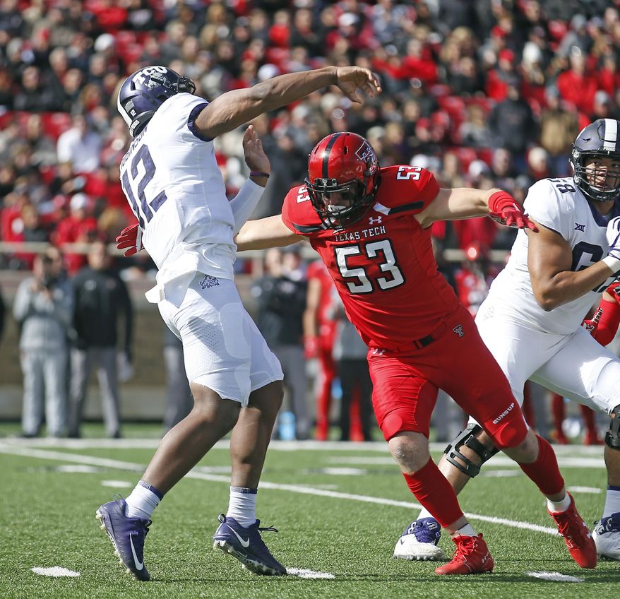 Texas Tech's Eli Howard (53) moves in as TCU's Shawn Robinson (12) throws a pass during the first half of the NCAA college football game Saturday, Nov. 18, 2017, in Lubbock, Texas. (AP Photo/Brad Tollefson)