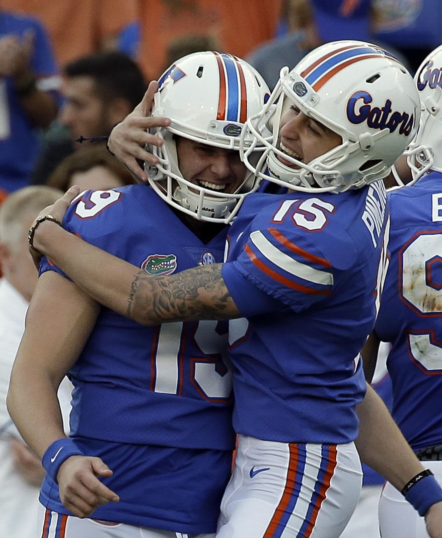Florida place kicker Eddy Pineiro (15) celebrates a 50-yard field goal against UAB with teammate Johnny Townsend (19) during the first half of an NCAA college football game, Saturday, Nov. 18, 2017, in Gainesville, Fla. (AP Photo/John Raoux)