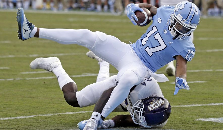 North Carolina's Anthony Ratliff-Williams (17) scores a touchdown while Western Carolina's Shamon Elliott tackles during the first half of an NCAA college football game in Chapel Hill, N.C., Saturday, Nov. 18, 2017. (AP Photo/Gerry Broome)