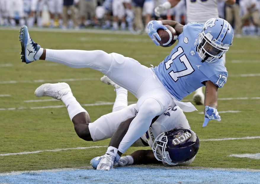 North Carolina's Anthony Ratliff-Williams (17) scores a touchdown while Western Carolina's Shamon Elliott tackles during the first half of an NCAA college football game in Chapel Hill, N.C., Saturday, Nov. 18, 2017. (AP Photo/Gerry Broome)