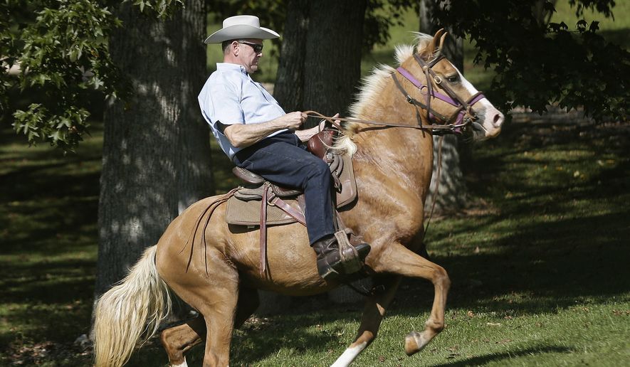 In this Tuesday, Sept. 26, 2017, file photo, former Alabama Chief Justice and U.S. Senate candidate Roy Moore rides in on a horse to vote at the Gallant Volunteer Fire Department during the Alabama Senate race in Gallant, Ala. (AP Photo/Brynn Anderson, File)